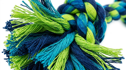 Colorful braided yarn rope with vibrant blue and green hues tightly knotted.