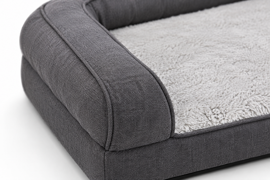 Close-up of a plush, gray dog bed with bolstered sides and soft fabric texture