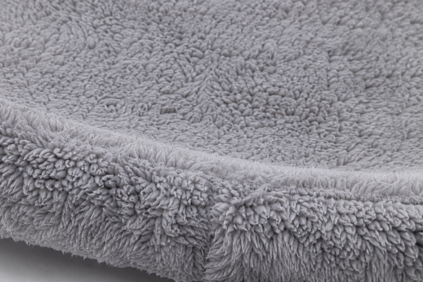 Close-up view of a soft, plush gray fabric with a dense, velvety texture