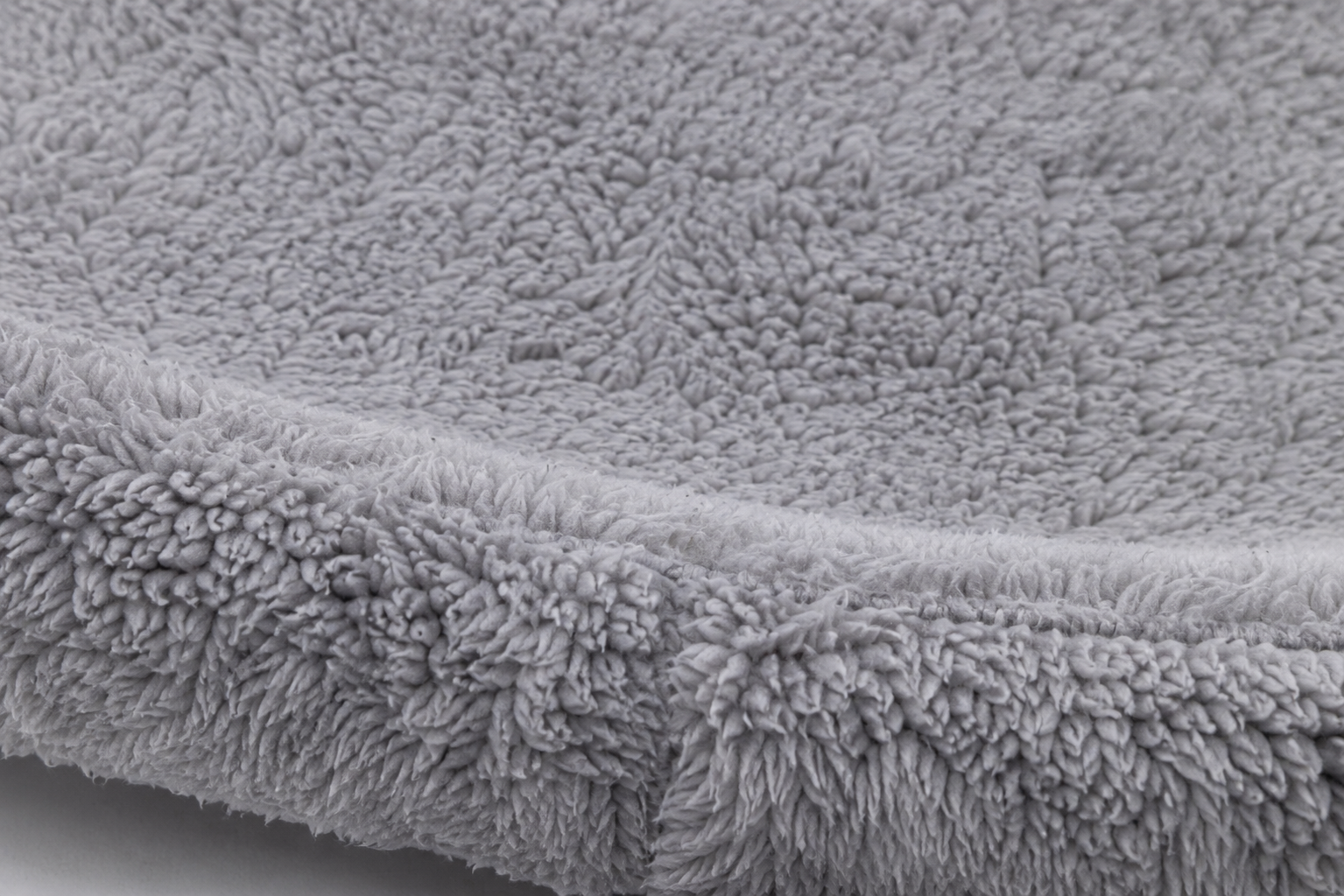 Close-up view of a soft, plush gray fabric with a dense, velvety texture