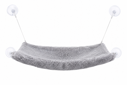 Gray fabric hammock suspended by two suction cups against a white background