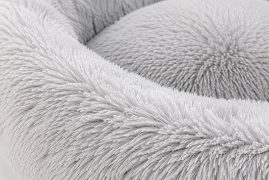 Close-up view of a soft, fluffy, light gray fabric with intricate texture